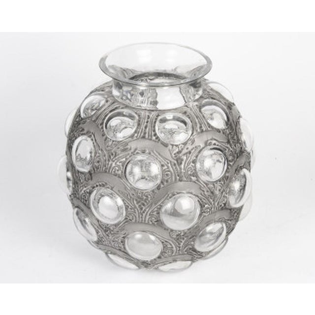 René Lalique – “Antelopes” Vase Pressed molded white glass vase, enhanced with a gray-black patina. Design created by René...