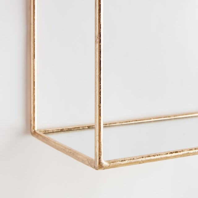 This generously-scaled arched pair of champagne gold wall shelves are a lovely design accent. With a shelf deep enough for...
