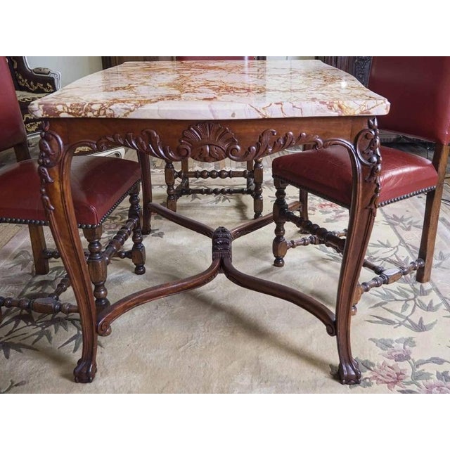 Neo-Rococo table decorated with hand carving with floral motifs. The thick and very heavy marble top is profiled with a...