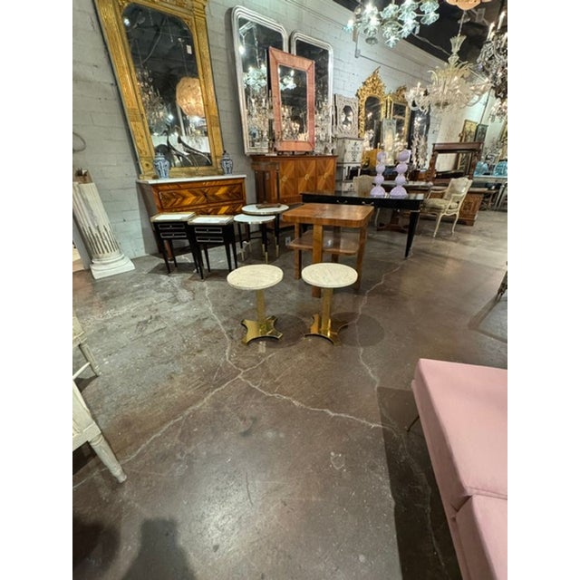 This pair of Italian MCM brass and travertine side tables is a stylish and elegant addition to any home. result is well...