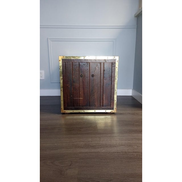 This piece of furniture is a Habersham Wooden Plantation Campaign Trunk Style End Table. It is frequently used as a side...