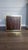 This piece of furniture is a Habersham Wooden Plantation Campaign Trunk Style End Table. It is frequently used as a side...