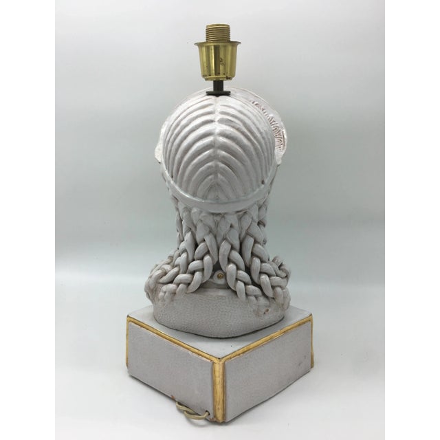 Bust of a Greco-Roman maid in white and gold ceramic table lamp, 1950s. European Plug (up to 250V).The wiring of this item...