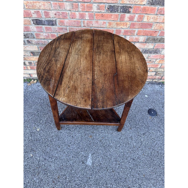 This English cricket table is wonderfully patinated and showcases the lovely grain found within the round top. The base is...