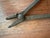 A curated collection of two authentic hand-forged iron workshop tools dating to the late 19th or early 20th century. This...