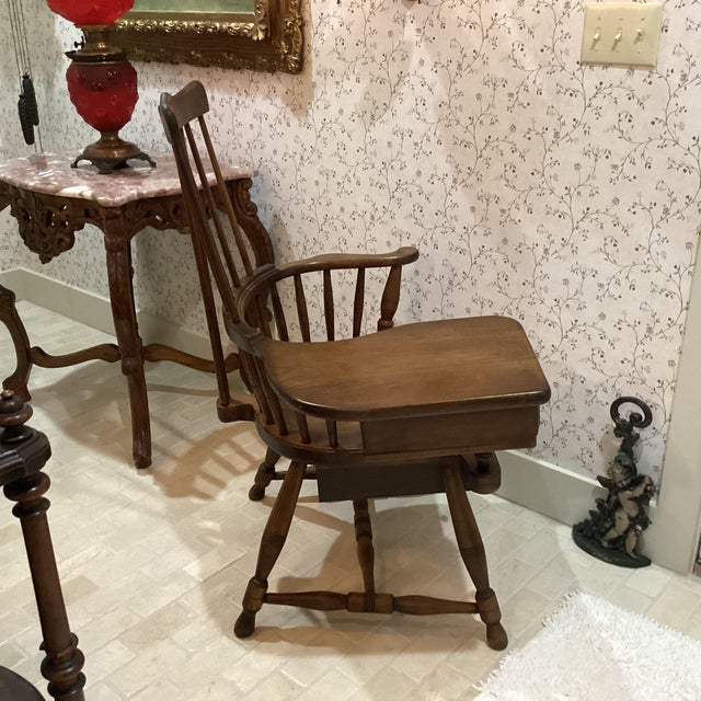 The Antique Large Wallace Nutting Windsor Style Writing Arm Chair with Drawers is a piece of vintage furniture that exudes...