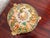 This round porcelain Italian Capodimonte lidded bowl is covered in raised relief cherubs at play among trees and flowers....