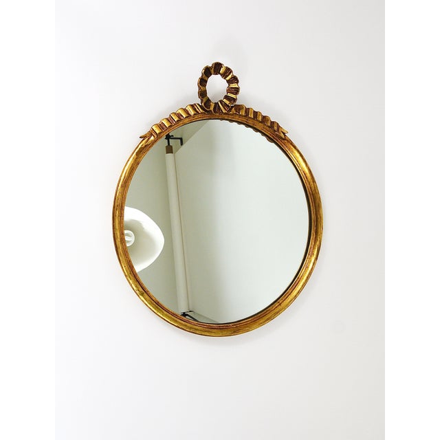 A absolutely lovely golden Hollywood Regency wall mirror from the 1950s, executed by C. Allodi & G. Subelli. Made in...