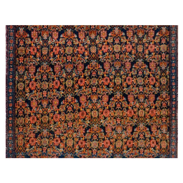 An incredible early 20th century Persian Senneh rug with an all-over trellis floral pattern woven in myriad colors...