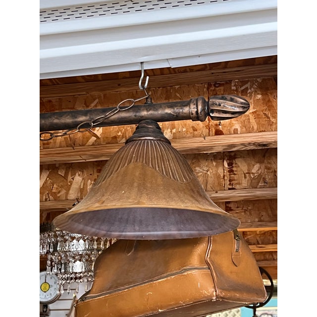 Three light bar pendants light. The long bar measuring 55” long . Includes a chain to hang this pedestal light. The tiger...