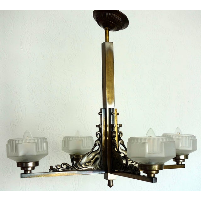 French Art Deco Brass and Satin Glass 4-Light Chandelier, 1920s, in Very Good conditions. Designed 1920 to 1949 I have...