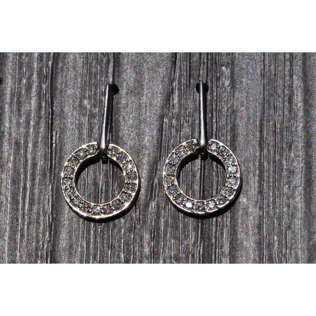 The Tooborac: White Gold and Diamond Dangler Earrings. The earrings feature white gold straight bars which dangle holding...