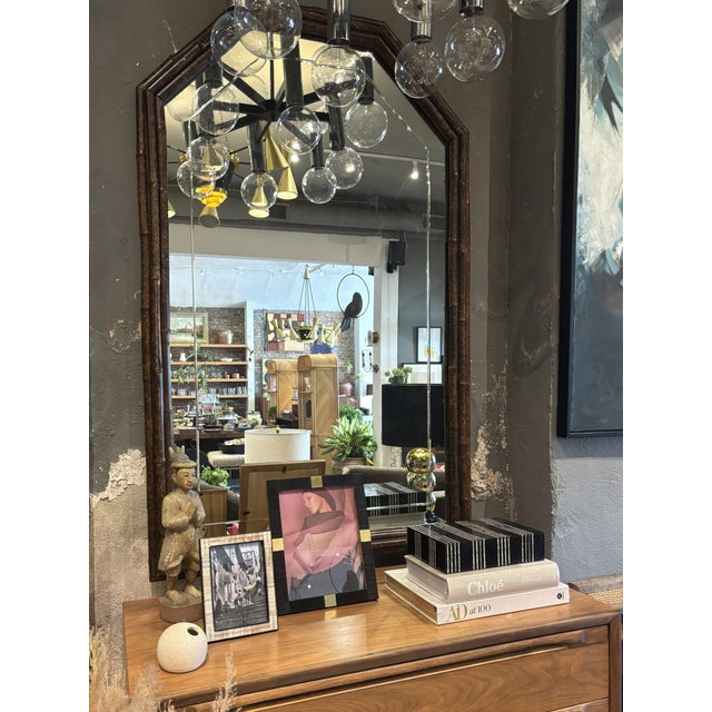 A beautiful and functional mirror in an asymmetrical octagonal shape with an arched top. The distinctive rich brown frame...