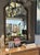 A beautiful and functional mirror in an asymmetrical octagonal shape with an arched top. The distinctive rich brown frame...