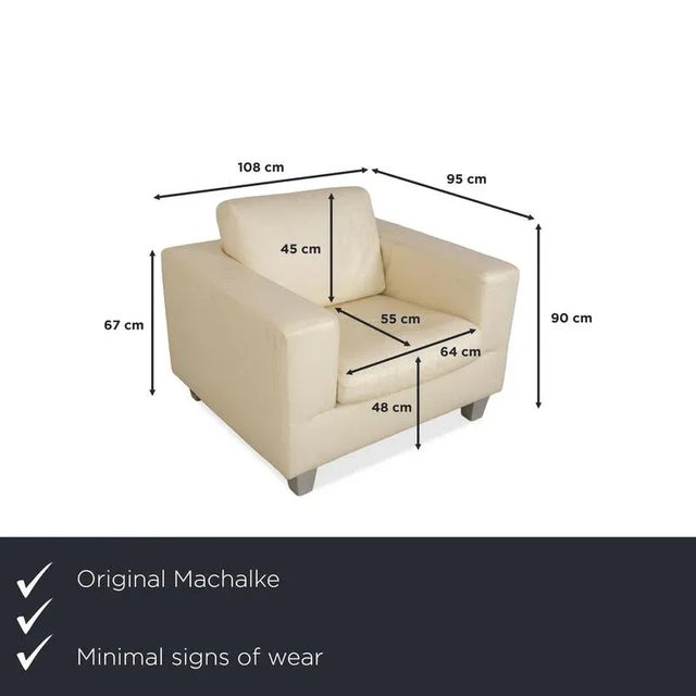 This armchair from Machalke is upholstered in cream-colored genuine leather and stands on silver wooden feet. Its simple,...