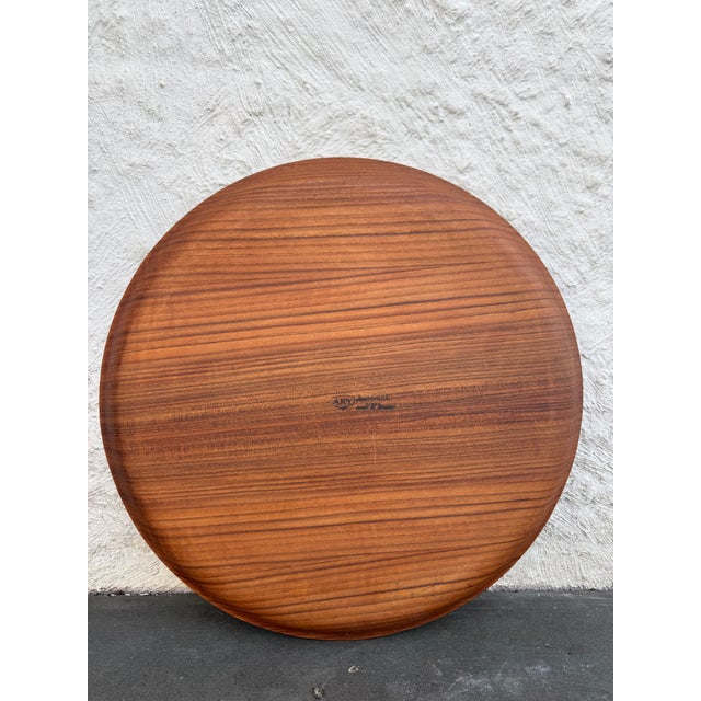 Ary Nybro bentwood round teak veneer tray. The manufacturer’s mark is located at the bottom of the tray.