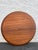 Ary Nybro bentwood round teak veneer tray. The manufacturer’s mark is located at the bottom of the tray.