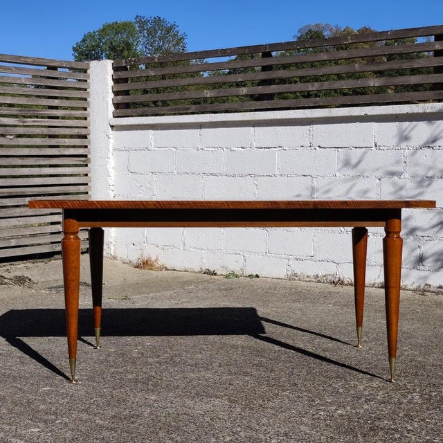 Absolutely stunning French Mid-Century Modern dining table from the 1960s. The table features a highly figured, dramatic...