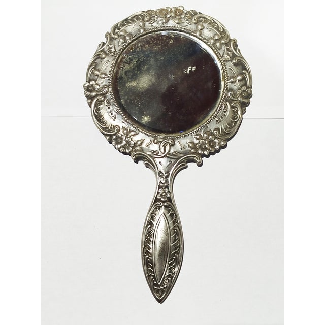 Silver Hand Mirror - 19th Century. 136 grams. Height: 9.85 in (25 cm)Width: 5.52 in (14 cm)Depth: 0.4 in (1 cm). This...