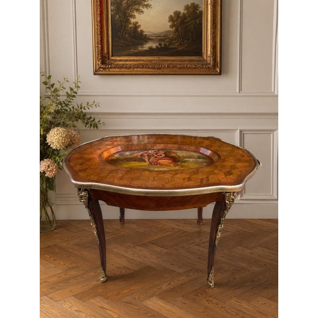 A beautifully decorative Italian parquetry inlaid tray table featuring a shaped top with geometric wood inlay, an inset...