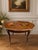 A beautifully decorative Italian parquetry inlaid tray table featuring a shaped top with geometric wood inlay, an inset...