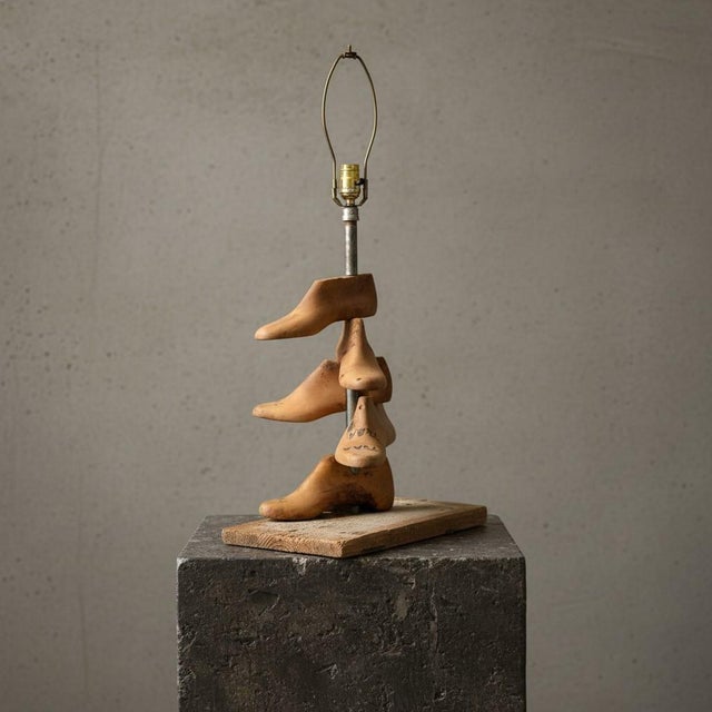 A compelling piece of American folk art, this sculptural lamp is composed of authentic vintage wooden shoe lasts—tools...