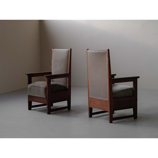 Striking pair of solid oak armchairs characteristic of the architectural style of the Amsterdam School in the 1930s. Their...