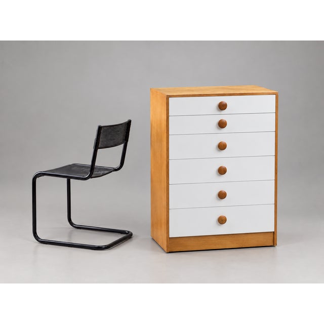 The apartment image and plain background are AI-generated from real photos; the furniture and chair are cut out. The chair...