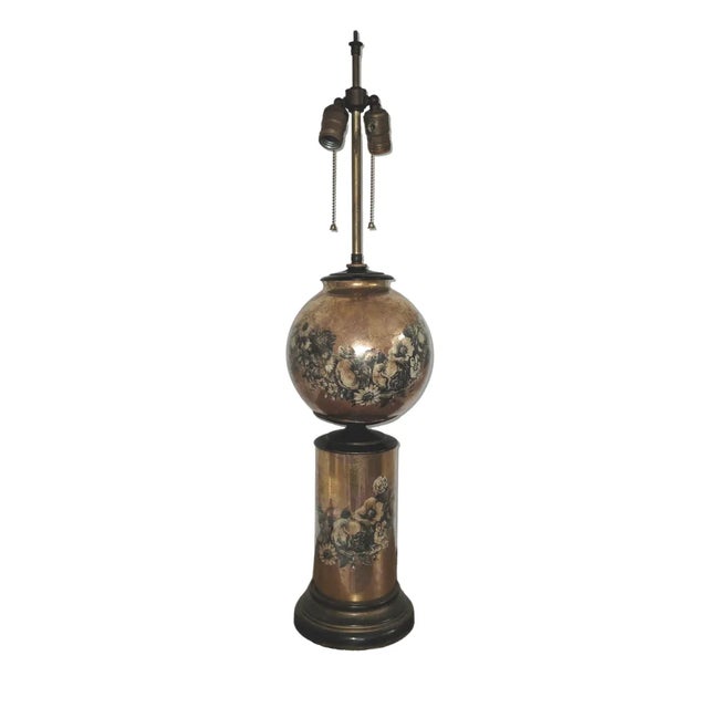 A striking example of 1930s decorative lighting, this gold gilt table lamp features a hand-gilded verre églomisé (reverse-...