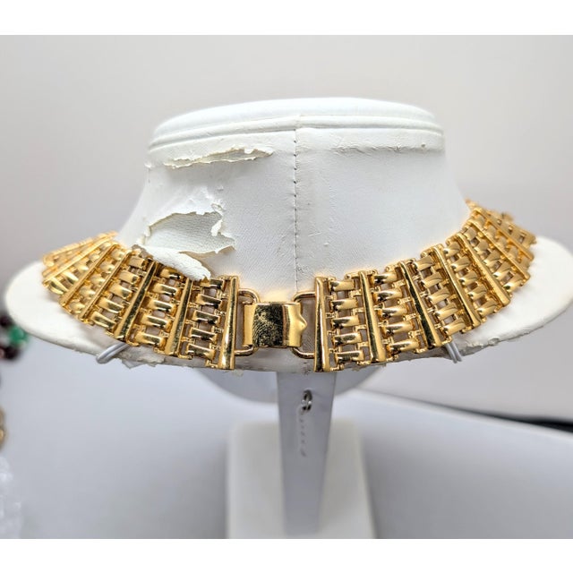 Circa 1989 goldtone wide interlocking links collar necklace with fold over clasp. Marked "NAPIER ©" on the back of the...