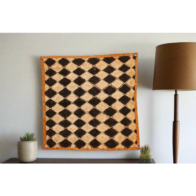 A captivating masterpiece of African textile art, this vintage Kuba cloth panel is a testament to the unparalleled...