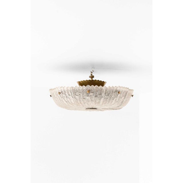 This very rare ceiling lamp, designed by Carl Fagerlund and produced by Orrefors in Sweden during the 1960s, is a refined...