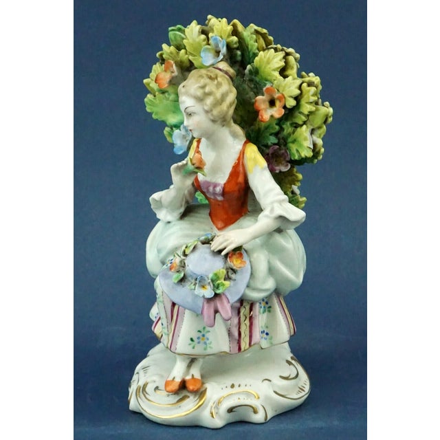 A polychrome hard-paste porcelain sculpture, entirely hand-decorated, signed under the base with a crowned "N" in blue...