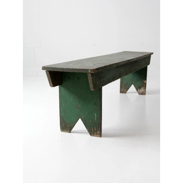 A charming antique primitive wooden bench with a beautifully timeworn farmhouse sensibility. Finished in a rustic green,...