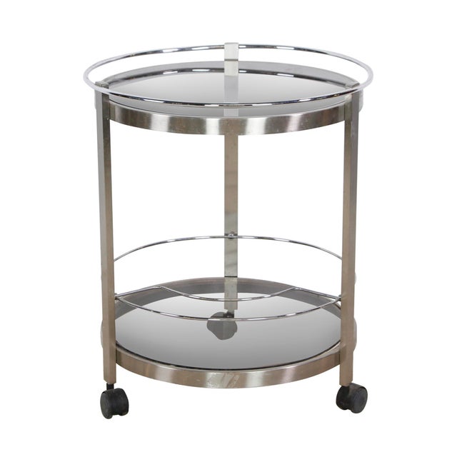European Modern vintage bar cart with nickeled steel frame and tinted glass shelves. The round design adds sleek style,...
