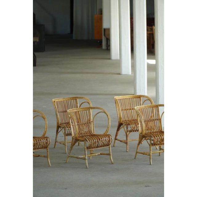 A beautiful and rare set of 6 danish armchairs / dining chairs by renowned copenhagen wicker maker r. Wengler. Crafted in...