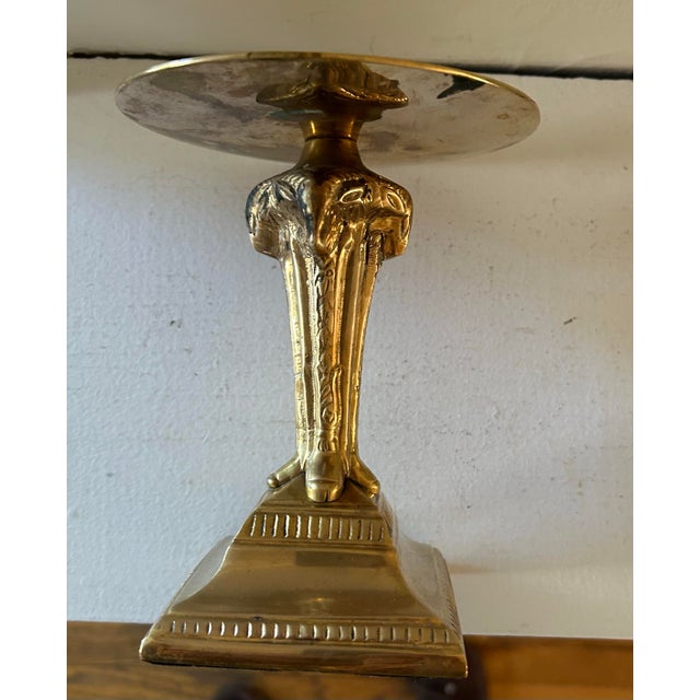 Vintage mid century solid brass pillar candle holder. Features four ram heads, one on each side. Stands 6” tall, 4.5"...
