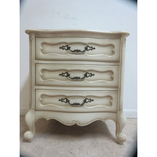 A vintage carved and painted nightstand. Great shape. tight and sturdy.. Minor scratches and rub marks.