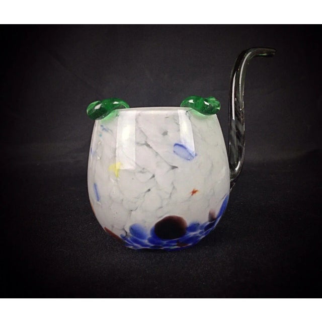 This unique ashtray or catch-all is crafted in the shape of a pipe, made from hand-blown glass. Its vibrant multicolored...