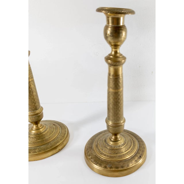 We are selling this pair of Charles X French candlesticks. These bronze candlesticks have nice geometric style designs...