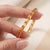 Elevate your everyday look with this elegant, light-catching tennis bracelet featuring a seamless row of warm, golden...