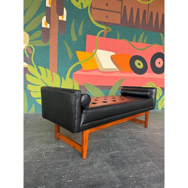 Mid Century Modern tufted even arm bench in black vinyl and walnut attributed to Selig circa 1960’s. Comes with two...