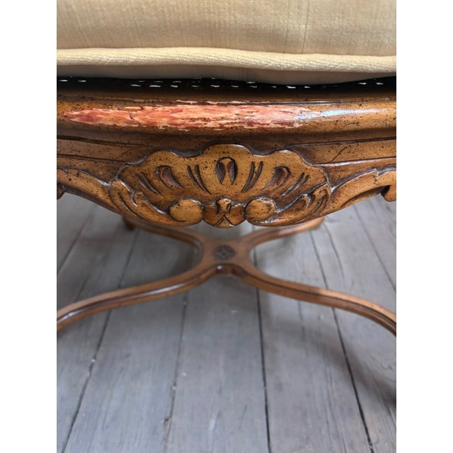 VIntage carved and caned French fauteuil chair with padded arms and a loose seat cushion. The caning is in very good...