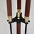 Four piece set of mid-century modern fireplace tools. Features wrought iron frame and tools with wooden handles and brass...