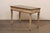 An Italian painted wood console table with drawers. This vintage table from Italy has a rectangular-shaped top over an...