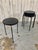 Set of four iron tripod legged stools / tables with ebonized wood tops. There is a nice patina of rust on the legs and...