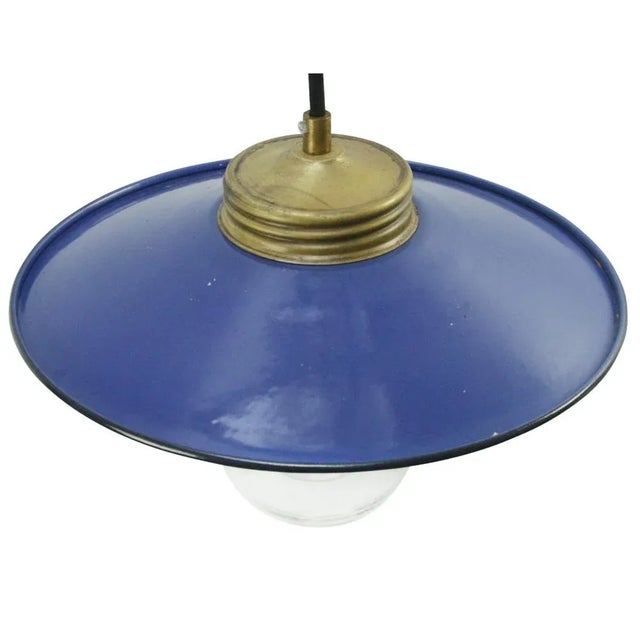 Blue enamel industrial hanging lamp. clear glass with brass top. e27 / e26 depending on destination, all our lights are...