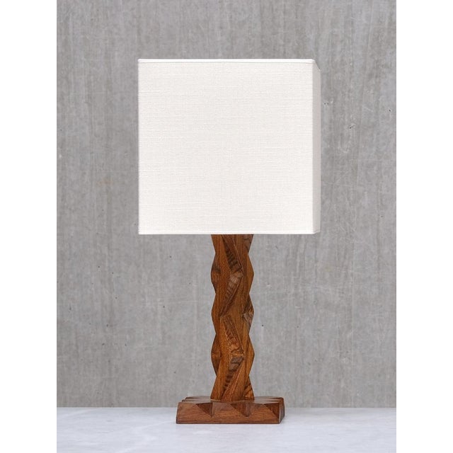 This table lamp originates from France and dates to the late 1930s. It features a geometric wooden base with a distinctly...
