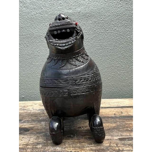 This striking hand-carved wooden box takes the form of a Chinthea, the mythical guardian lion of Southeast Asian folklore....