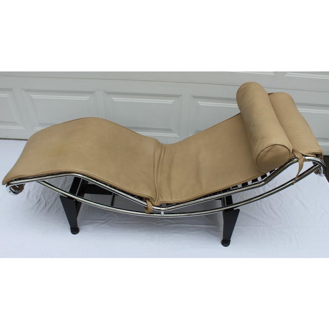Up for sale is a Lc4 Lounge Chair by Le Corbusier for Cassina. It is done in Tan leather with matching headrest. Overall...